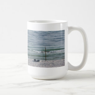 Bird on Wooden Cross by the Ocean Coffee Mug