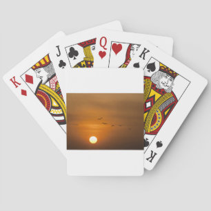 Birds flying in sunset playing cards