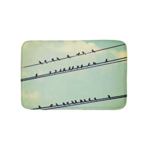 Birds on wires, vintage blue sky. bath mat