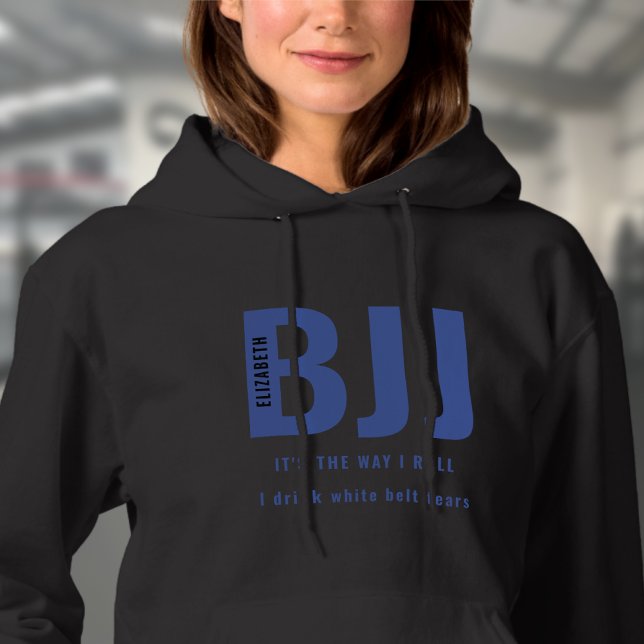 BJJ The Way I Roll Add Your Name Blue Belt Ladies Hoodie (Black woman's BJJ hoodie worn by a female model in the gym.)