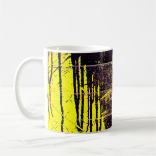 Black abstract splatter paint drips on a bright ye coffee mug