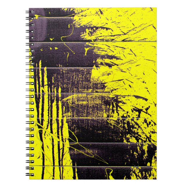 Black abstract splatter paint drips on a bright ye notebook (Front)
