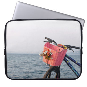 Black and blue bicycle with basket laptop sleeve