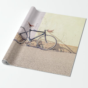 BLACK AND GRAY CITY BIKE LEANING ON WHITE WALL WRAPPING PAPER