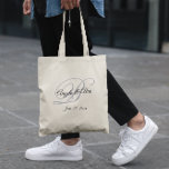 Black and Grey Fancy Monogram Wedding Welcome Tote Bag<br><div class="desc">Wedding favour welcome tote bags with a minimalist couple's monogram in a fancy calligraphy script in grey and black.
Customise the font style with the bride and groom's names and other text as needed. 
Customise the black and silver light grey colours.</div>
