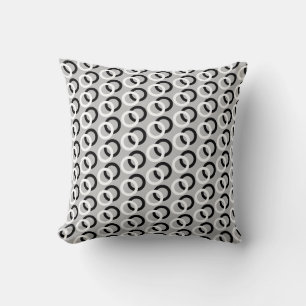 Black and white abstract circles on light grey cushion