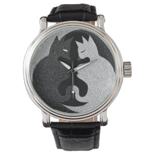 Black and white cats watch