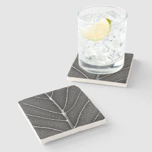 Black and white glowing leaf close-up stone coaster