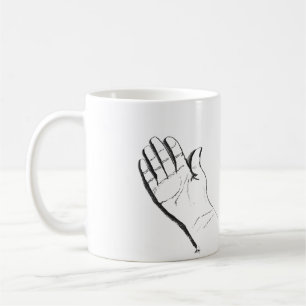 black and white hand on coffee mug