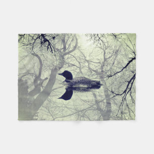 Black and white loon on a lake throw blanket