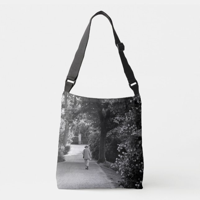 Black and white photo of old man at park crossbody bag (Front)