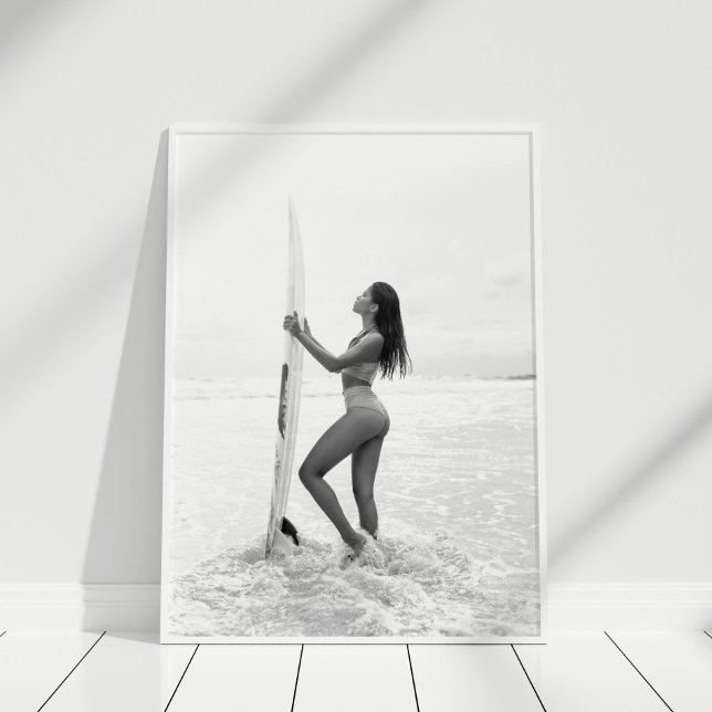 Black and White Surfer Girl on the Beach Poster (Black and White Surfer Girl on the Beach Poster in white frame on wooden floor.)
