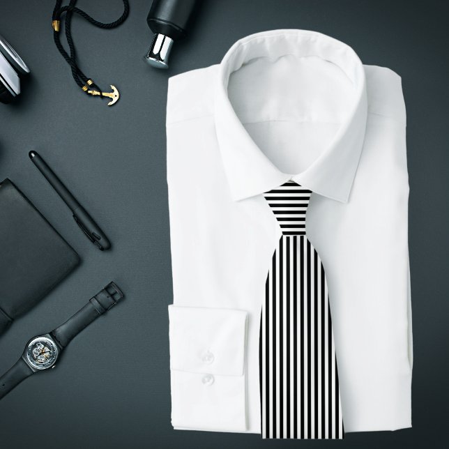 Black and White Thin Vertical Stripes Tie (A black and white vertical striped tie is featured on an assemblage of men's accessories.)