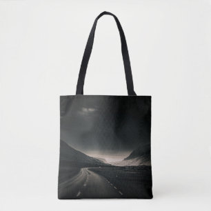 BLACK ASPHALT ROAD NEAR MOUNTAIN DURING DAYTIME TOTE BAG