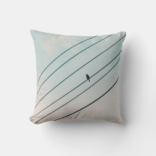 BLACK BIRD ON ELECTRIC WIRE UNDER BLUE SKY CUSHION