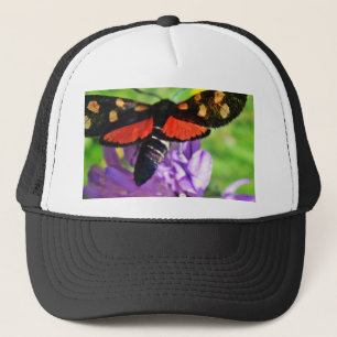 Black butterfly with red wings and red polka dots trucker hat