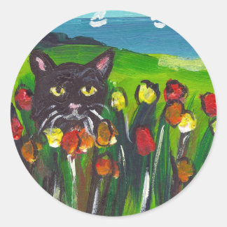 Black cat amongst tulips classic round sticker