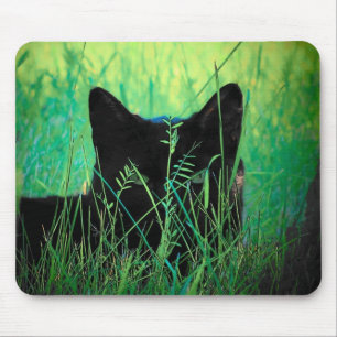 Black cat in the grass mouse pad