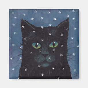 black cat in winter snow magnet