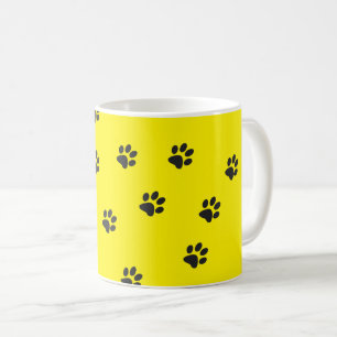 Black cat paws on yellow background coffee mug
