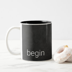 Black chalkboard with word "begin" Two-Tone coffee mug