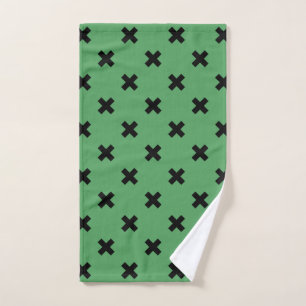 Black cross stitches on green hand towel