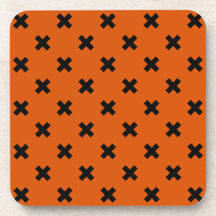 Black cross stitches on orange coaster