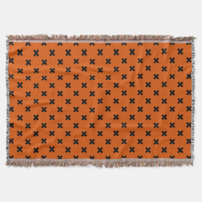 Black cross stitches on orange throw blanket (Front)