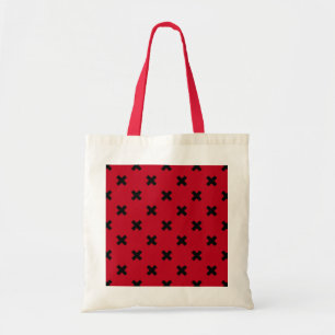 Black cross stitches on red tote bag