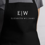 Black Elegant Modern Minimalist Monogram Name Apron<br><div class="desc">Elevate your culinary experience with our Classic Elegant Modern Minimalist Monogram Name Cooking Apron. This kitchen essential seamlessly merges timeless elegance with contemporary minimalism. Crafted with precision, this apron is not just a practical accessory but also a statement of personal style. The customisable monogram and name option allows you to...</div>