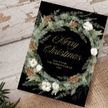 Black Elegant Pine Wreath | Gold Merry Christmas Holiday Card<br><div class="desc">This stunning dark holiday card features a Christmas wreath with elegant botanical greenery foliage,  and pine cones with festive white flowers on a black background. Modern faux gold script calligraphy says "Merry Christmas." The back has a matching design with room to add a personal message.</div>