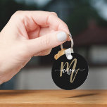 Black Gold Modern Script Girly Monogram Name Key Ring<br><div class="desc">Add a touch of elegance to your keys with the Black and Gold Modern Script Girly Monogram Name Keychain. This chic keychain features a sleek black design with a bold gold monogram in a modern script font, making it the perfect blend of luxury and personalisation. Whether you’re looking to jazz...</div>