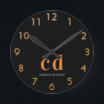 Black gold monogram initials name round clock<br><div class="desc">Personalise and add your monogram letters,  initials and name.  A classic chic black background colour.  White and golden coloured letters. Golden clock numbers.</div>