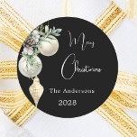 Black gold white baubles Christmas Classic Round Sticker<br><div class="desc">For a Christmas party favours or gift wrapping. An elegant,  modern black background. Decorated with white and gold baubles and some greenery and a pine cone.  Personalise and add your name,  year.  Text: Merry Christmas</div>