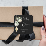 Black gold white baubles Christmas Square Sticker<br><div class="desc">For a Christmas party favours or gift wrapping. An elegant,  modern black background. Decorated with white and gold baubles and some greenery and a pine cone.  Personalise and add your name,  year.  Text: Merry Christmas</div>