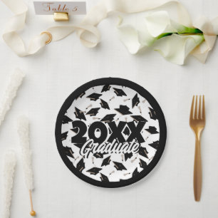Black Graduation Caps Tossed in the Air on White Paper Plate