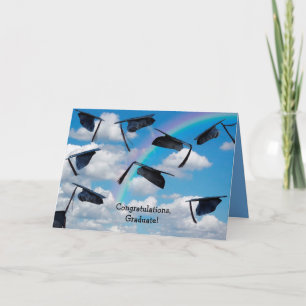 Black graduations caps in sky with rainbow card