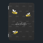 Black happy bumble bees summer fun humour monogram iPad mini cover<br><div class="desc">Decorated with happy, smiling yellow and black bumble bees. A chic black background. Personalise and add a name and your monogram, initials. The monogram in grey as a pattern in the background. The name is written in white with a modern hand lettered stylie script with swashes. To keep the swashes...</div>