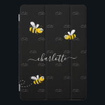 Black happy bumble bees summer fun humour monogram iPad pro cover<br><div class="desc">Decorated with happy, smiling yellow and black bumble bees. A chic black background. Personalise and add a name and your monogram, initials. The monogram in grey as a pattern in the background. The name is written in white with a modern hand lettered stylie script with swashes. To keep the swashes...</div>