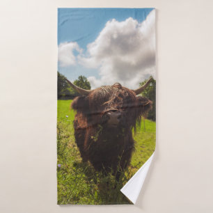 Black highland cow grazing green field sun light bath towel set