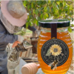 Black Honey Label Sunflower and Metallic Gold Text<br><div class="desc">Black Label with Vintage Sunflower illustration and Realistic Bee features a double white border circling your Apiary Name and Location. Apiary name is displayed in curved text across the top and the beekeeper's name, city and town are written in curved text on the lower half of the label. There is...</div>