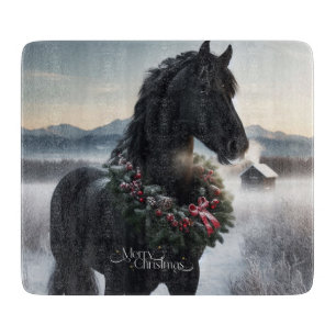 Black horse in the snow with Christmas wreath Cutting Board
