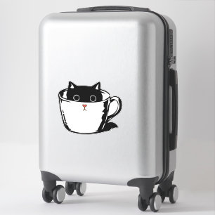 Black kitten with red nose hiding in a cup