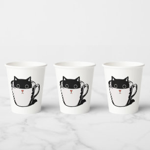 Black kitten with red nose hiding in a cup
