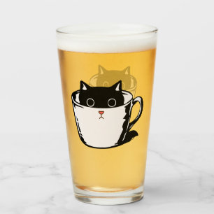 Black kitten with red nose hiding in a cup