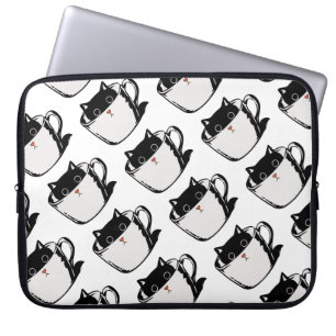 Black kitten with red nose hiding in a cup laptop sleeve
