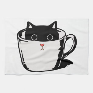 Black kitten with red nose hiding in a cup tea towel