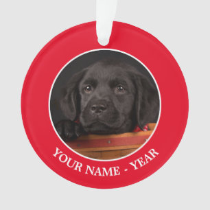 Black labrador retriever puppy in a basket ornament