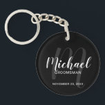Black Modern Script Personalised Groomsmen Key Ring<br><div class="desc">Add a personal touch to your wedding with personalised groomsmen keychain. This keychain features personalised groomsmen's name in white modern script font style and monogram in grey modern script font style as background with title and wedding date in white modern sans serif font style on black background. Also perfect for...</div>