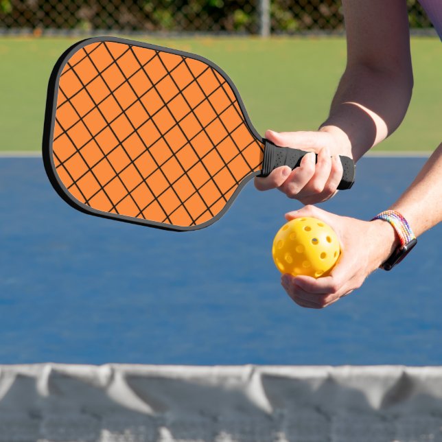Black net mesh on orange pickleball paddle (Insitu)